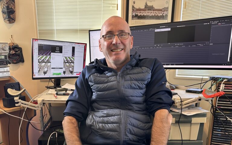Jai Waite sits at his desk in his home office.