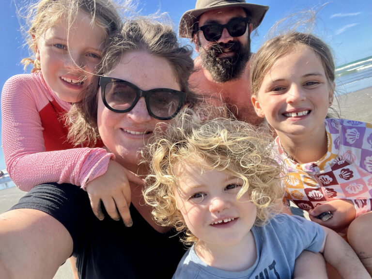 A selfie taken by Rachel Barr and with her husband and three kids on a beach.