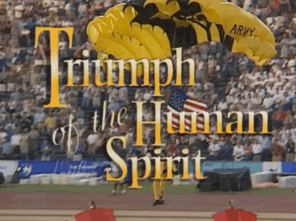 Title frame from the documentary "Triumph of the Human Spirit" showing base jumper landing in the stadium of the opening ceremony.