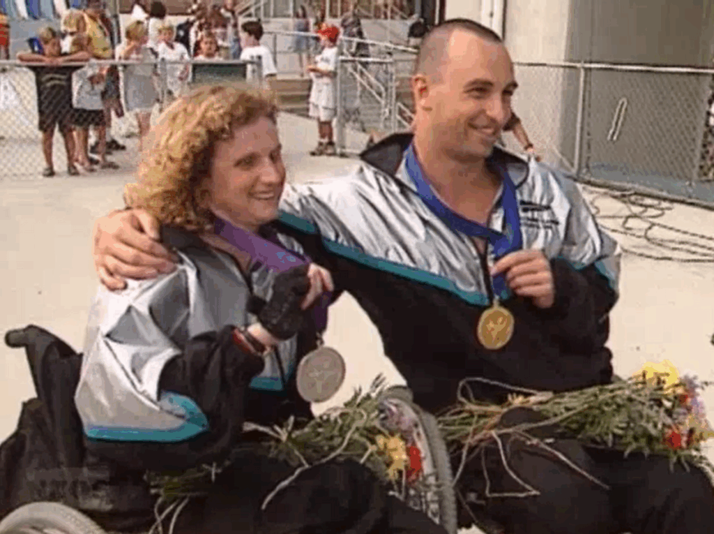 Duane Kale and Jenny Newstead hold their Paralympic medals from Atlanta 1996.