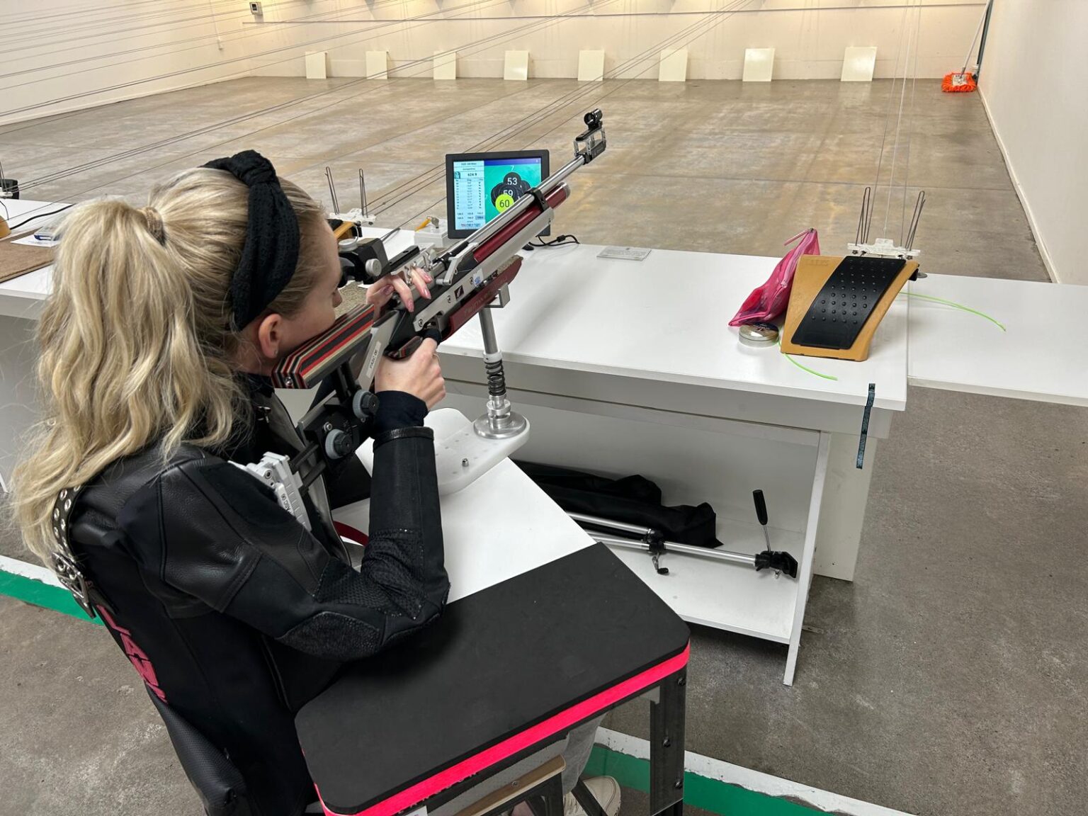 Liz Langdon aims a rifle at a shooting range.