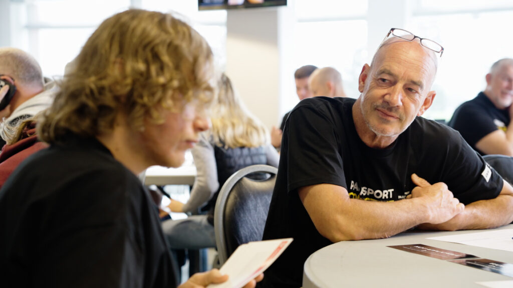 Henk Greupink sits at a table at a Para Sport Collective camp.