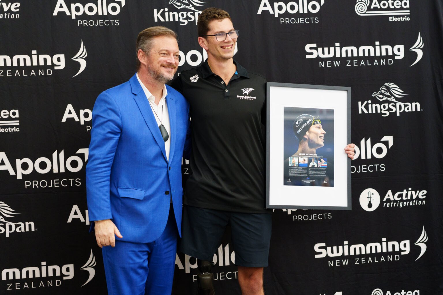 Jesse Reynolds is presented with a commemorative frame to mark his retirement from Para swimming by IPC President Andrew Parsons.