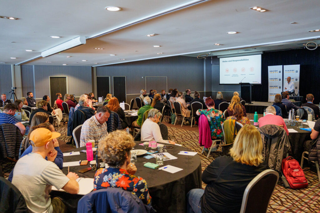Tables of participants look to the stage at the Para Sport Collective Hui hosted by Paralympics New Zealand on 25 August 2025.