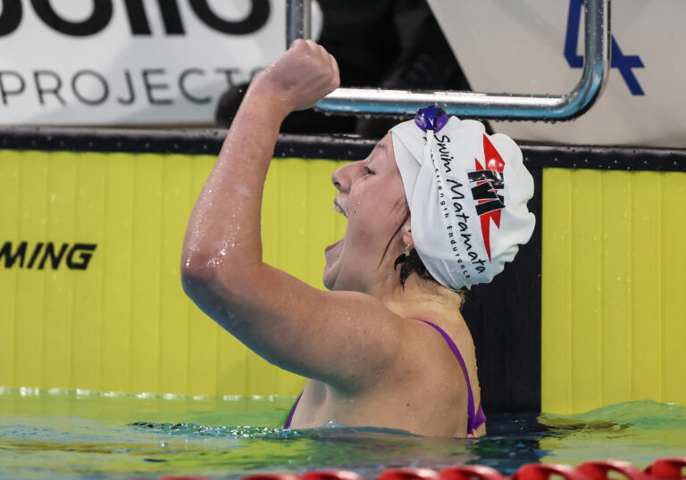 Rylee Sayer celebrates in the pool following a siwmming race.