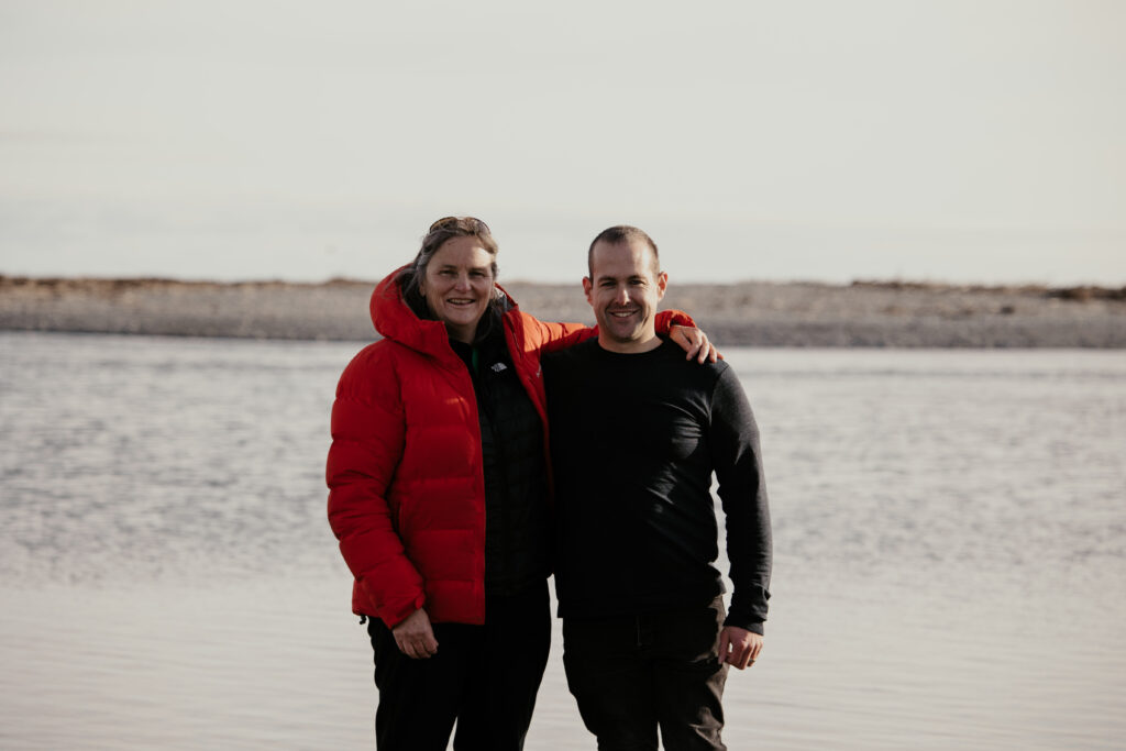 Jane Stevens stands with Paralympian #158 Adam Hall.