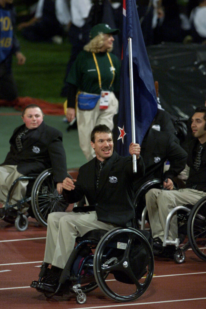 Paralympian #99 Ben Lucas carries the NZ Flag for the opening ceremony of the Sydney 2000 Paralympic Games.