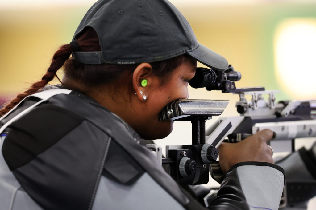 Neelam O'Neill looks down the sight of a rifle during competition.