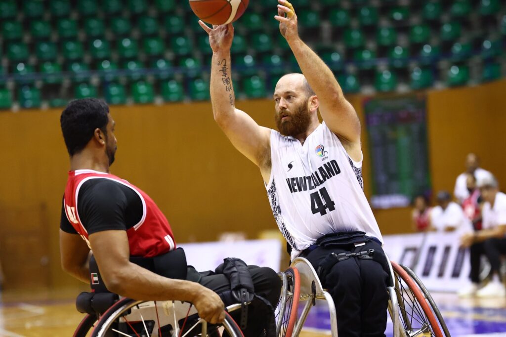 Eamon Wood lifts a basketball in the air during a game of Wheelchair Basketball.
