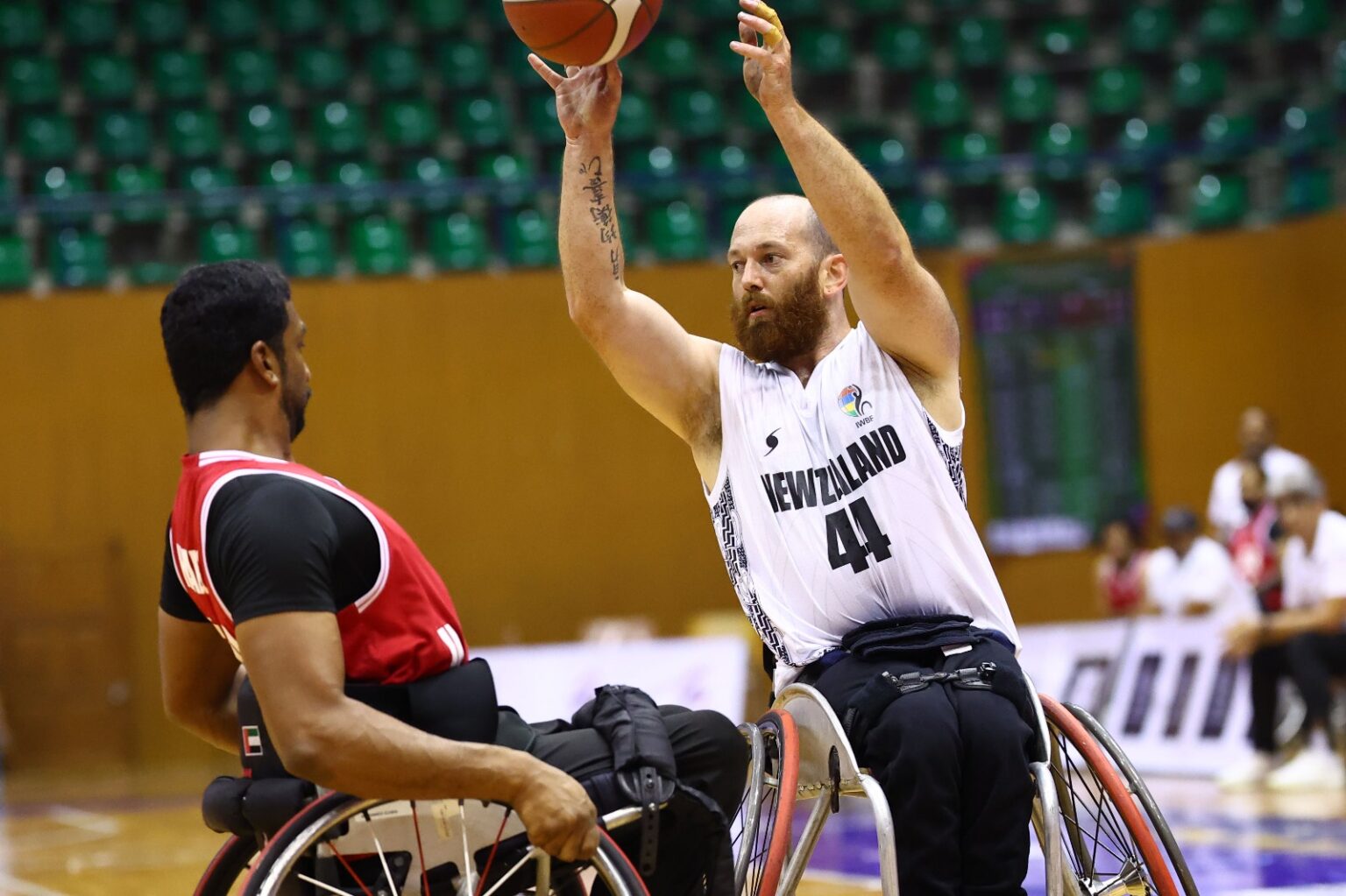 Eamon Wood lifts a basketball in the air during a game of Wheelchair Basketball.