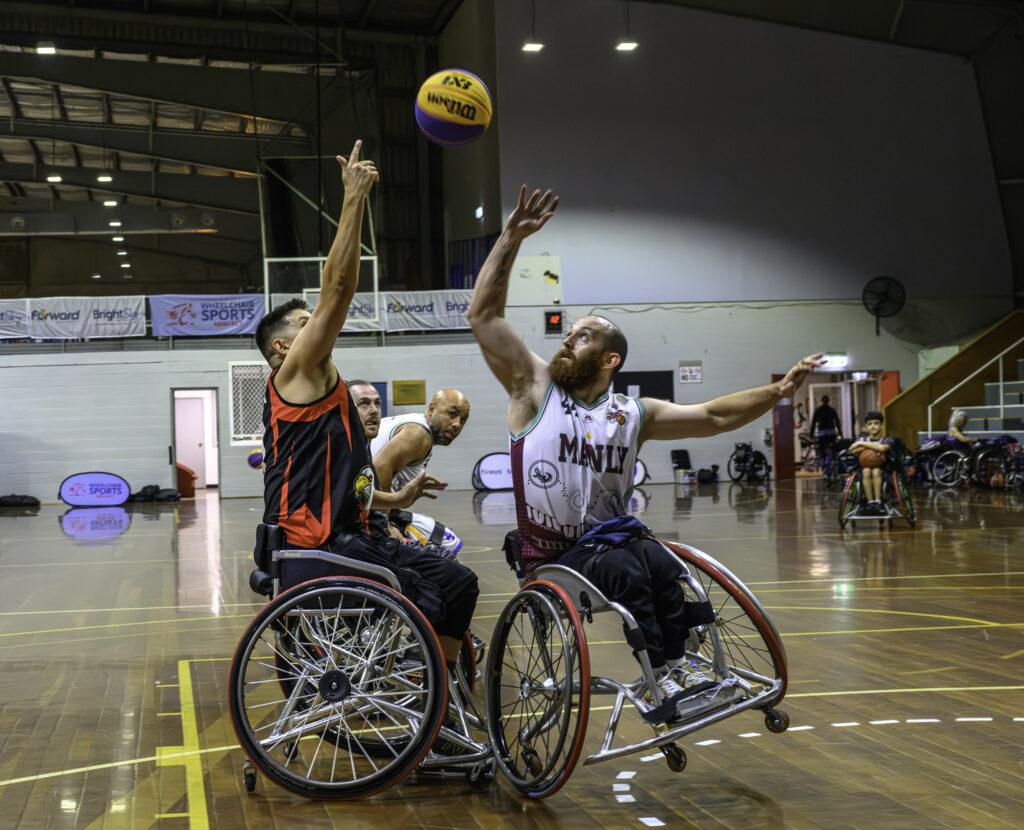 Eamon Wood reaches into the air to catch a ball during a game of Wheelchair Basketball.