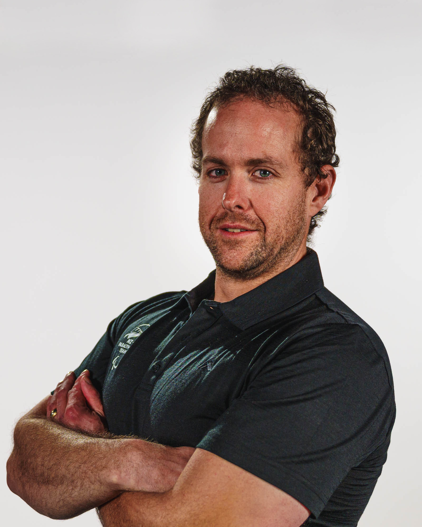 A portrait of Adam Hall on a white background.