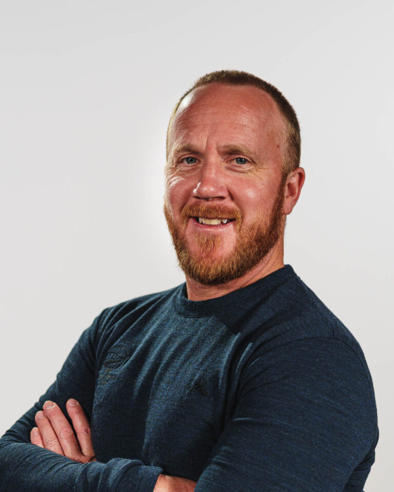 A portrait of Corey Peters on a white background.