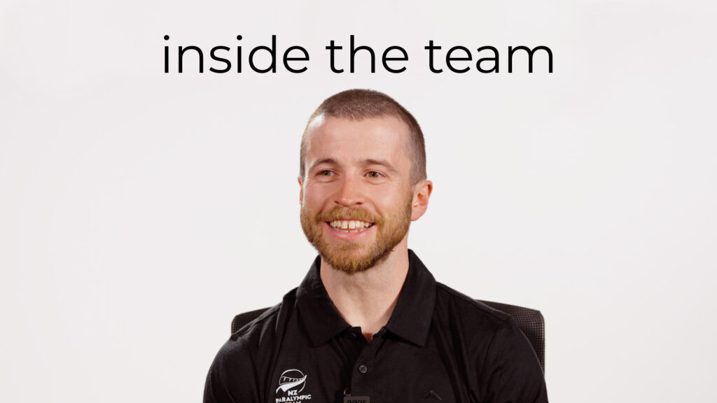 Sam Lynch smiles infront of a white backdrop, with text above reading "inside the team"