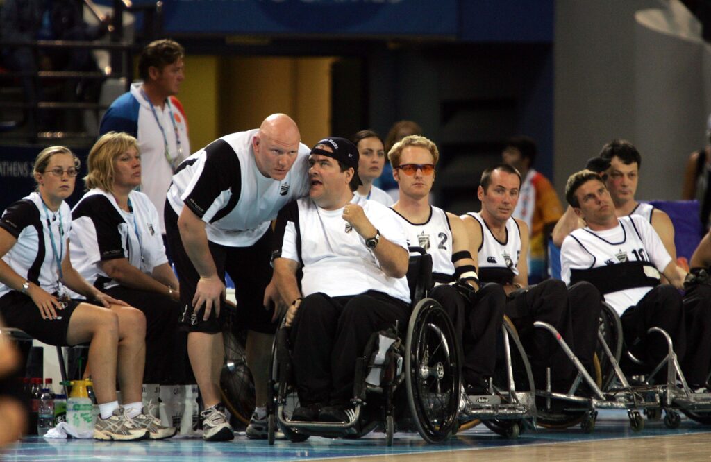 Grant talks to Ashley standing beside him on the sidelines.