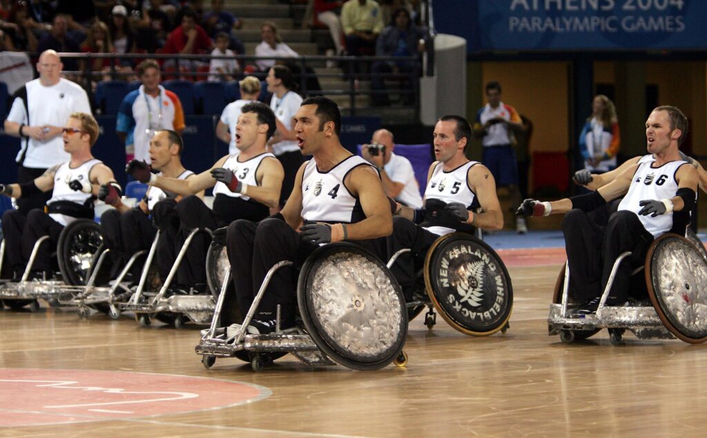 Jai, surrounded by his team, performs the haka with the Wheelblacks.