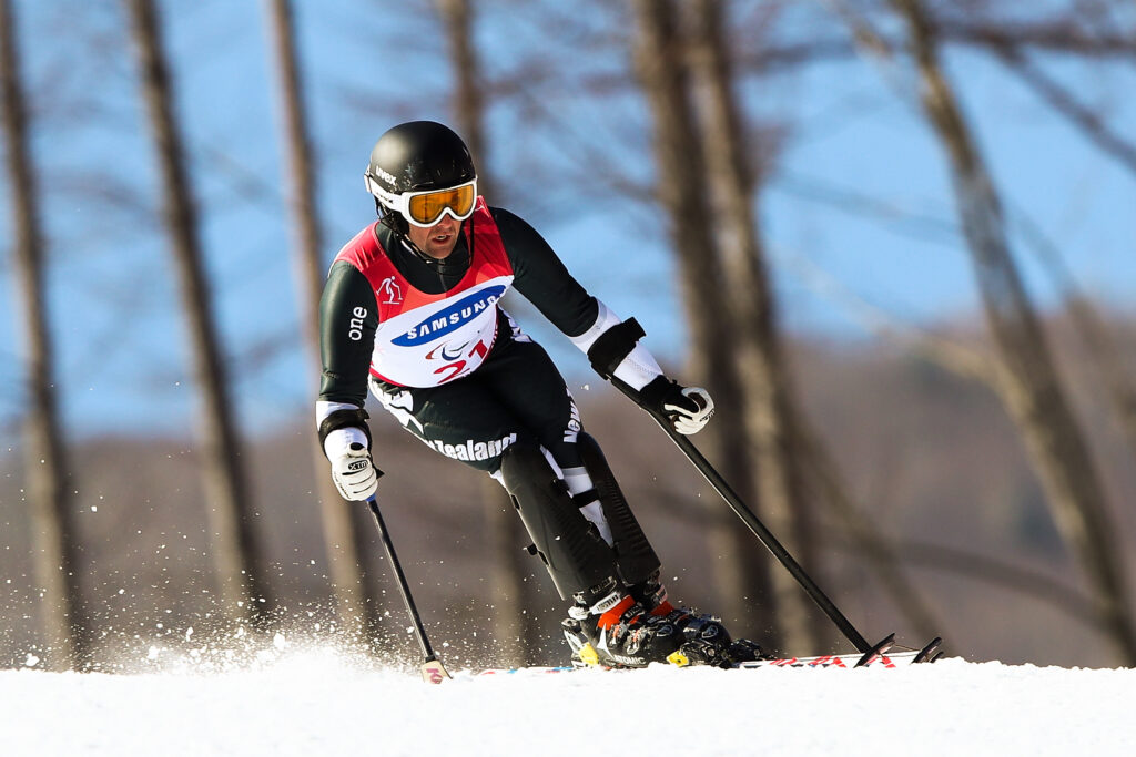 Adam Hall skis down a snowy mountain. 