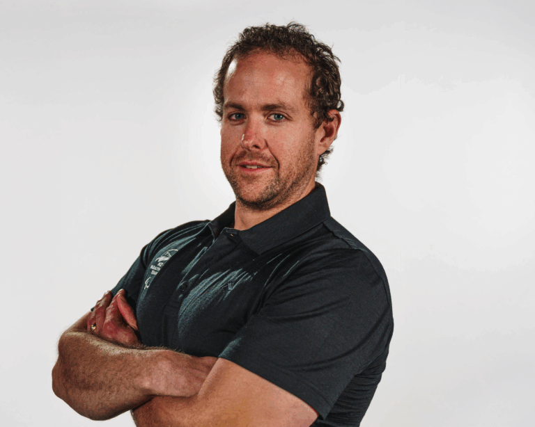 A portrait of Adam Hall on a white background.