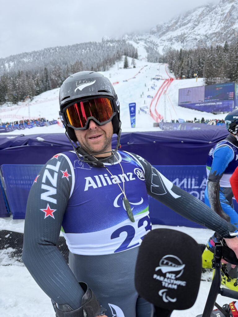 man in ski gear at bottom of ski run