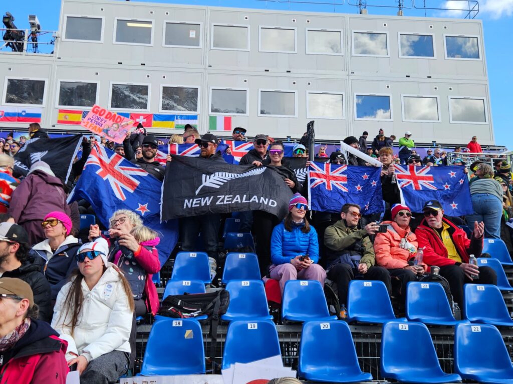 group of supporters holding NZ flags