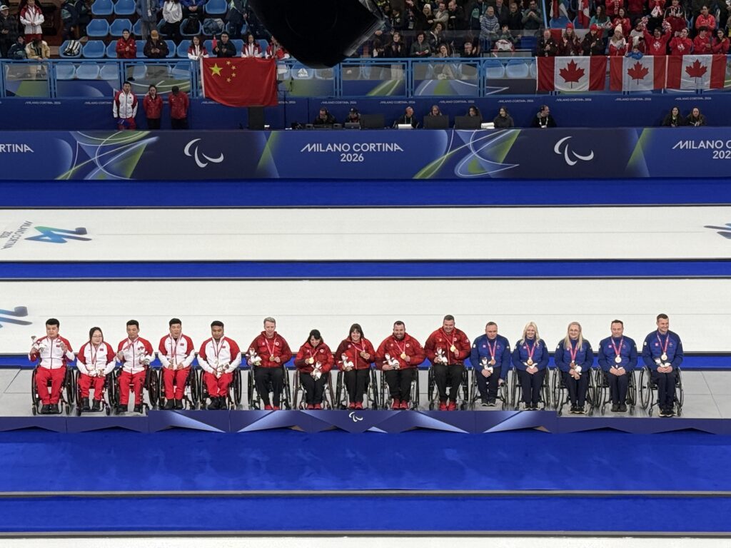 line up of three teams of medalists