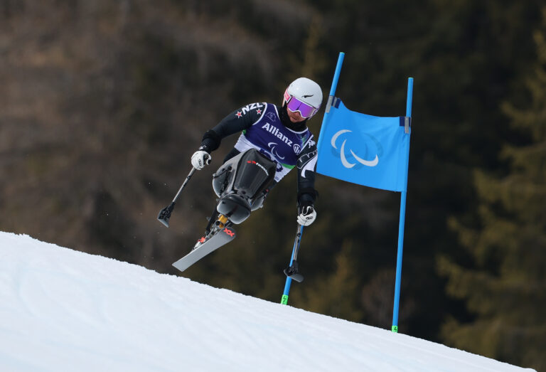 Sit skier Corey Peters is airborne jumping of a hill in the Men's Super-G Sitting at the Milano Cortina 2026 Paralympic Winter Games.
