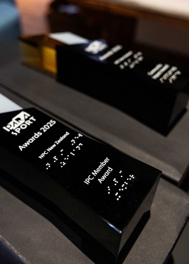close up image of a trophy.  The trophy is inscribed with words and braille