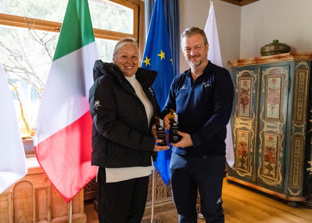 Two people pictured with trophies