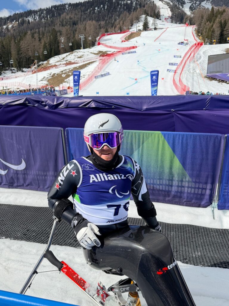 Corey Peters sits in his ski gear in the mixed zone at Milano Cortina 2026.