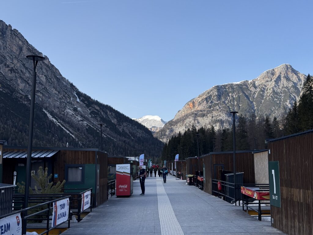 A street lined with cabins set against the backdrop of mountains