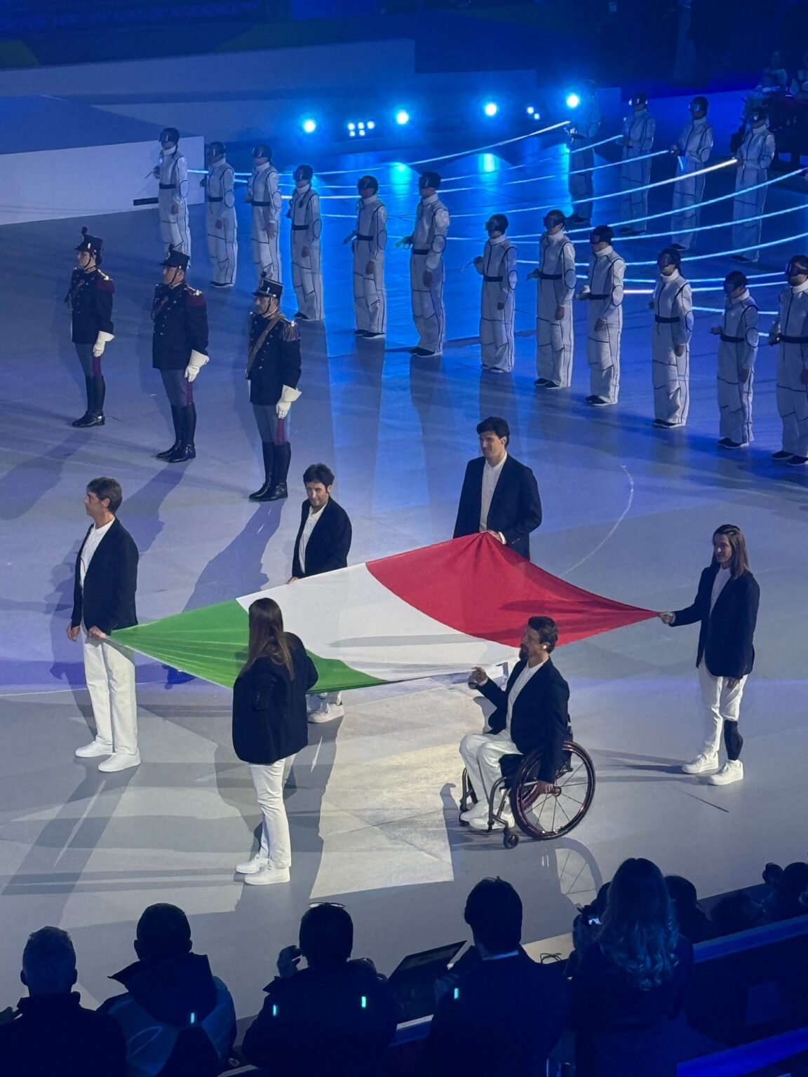 Six people carrying in the Italian flag