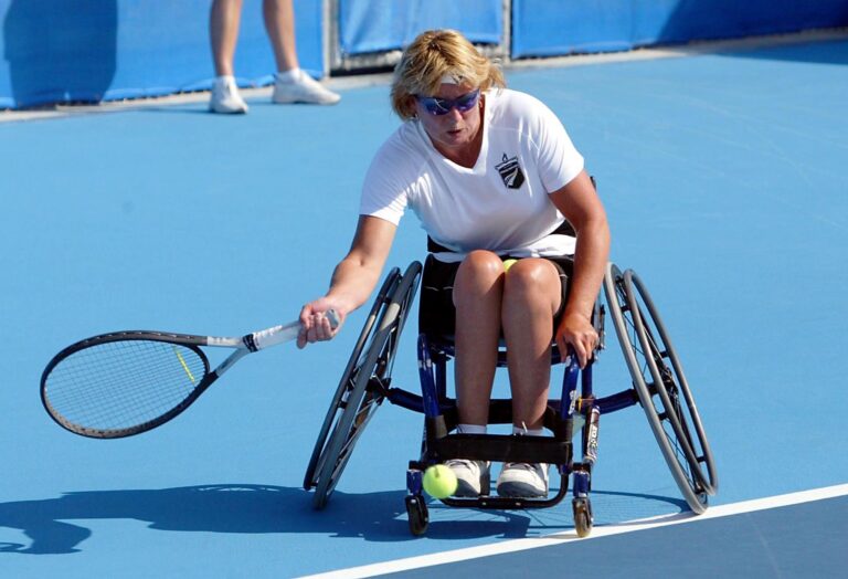 Tiffiney Perry swings the racquet in a game of Wheelchair Tennis at Athens 2004.