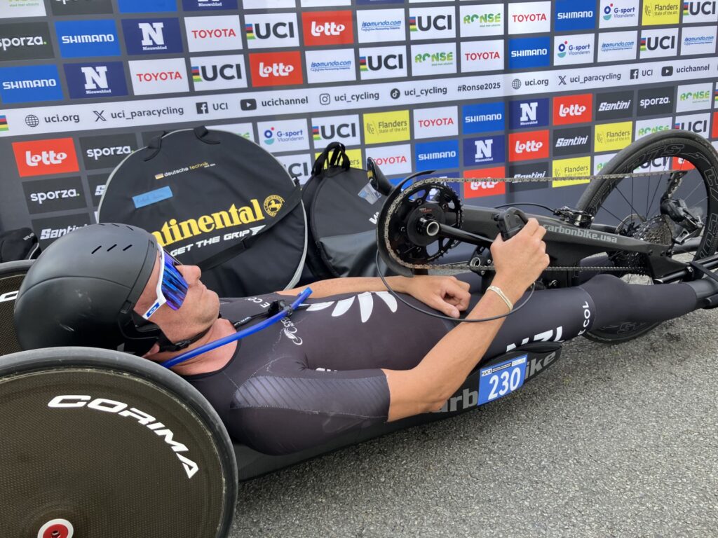 A close up photo of Rory Mead in his handcycle at the end of a road race. 