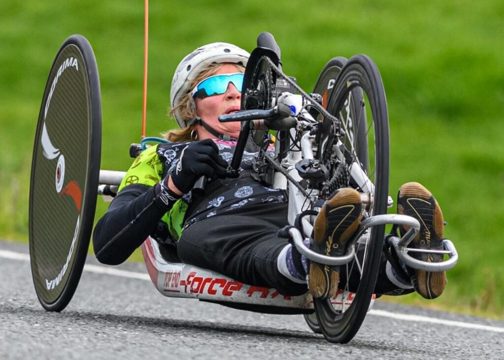 Tiffiney pedals a hand cycle in a road race.