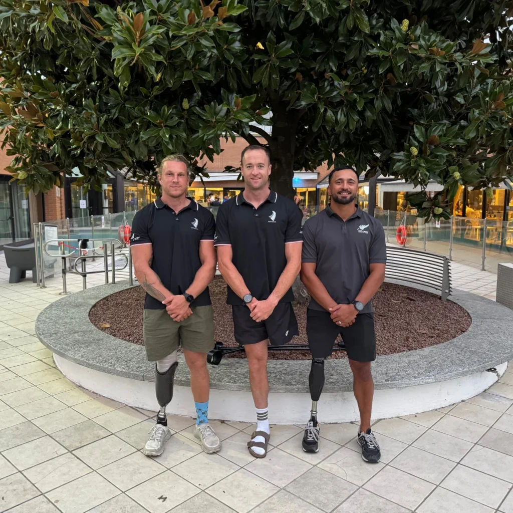 Finn Murphy stands with Paralympians Scott Martlew and Peter Cowan.