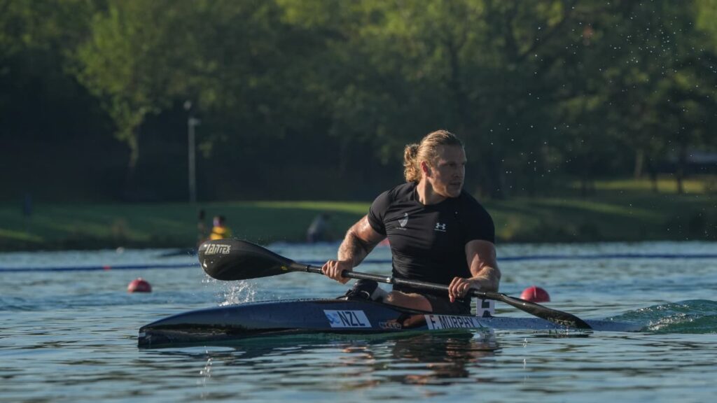Finn Murphy paddles a canoe on the water.