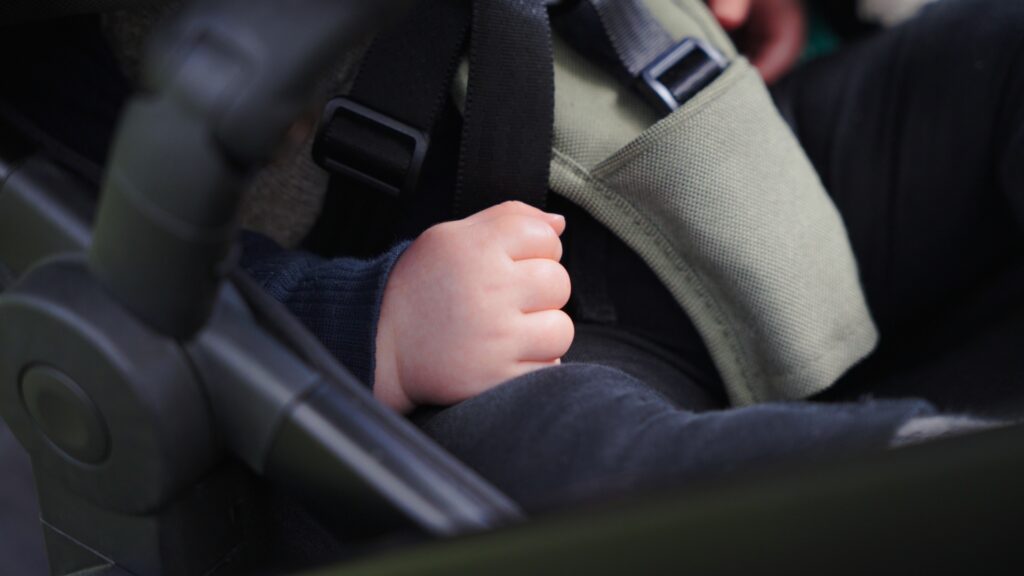 A close up photo of Henry's hand in the pram.