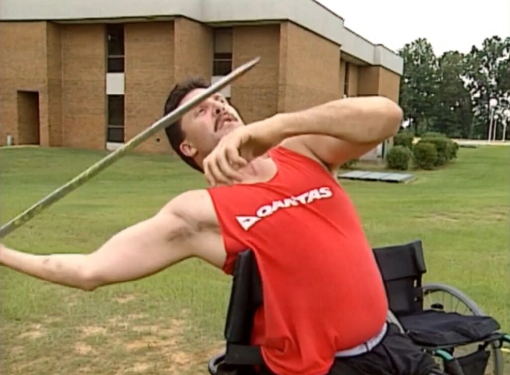 Dave MacCalman throws a javelin from his wheelchair.
