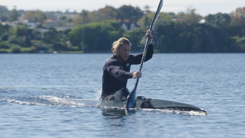 Finn Murphy paddles a canoe in Auckland.