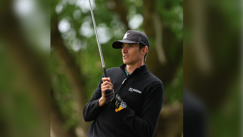 Guy Harrison holds a gold club during a tournament.