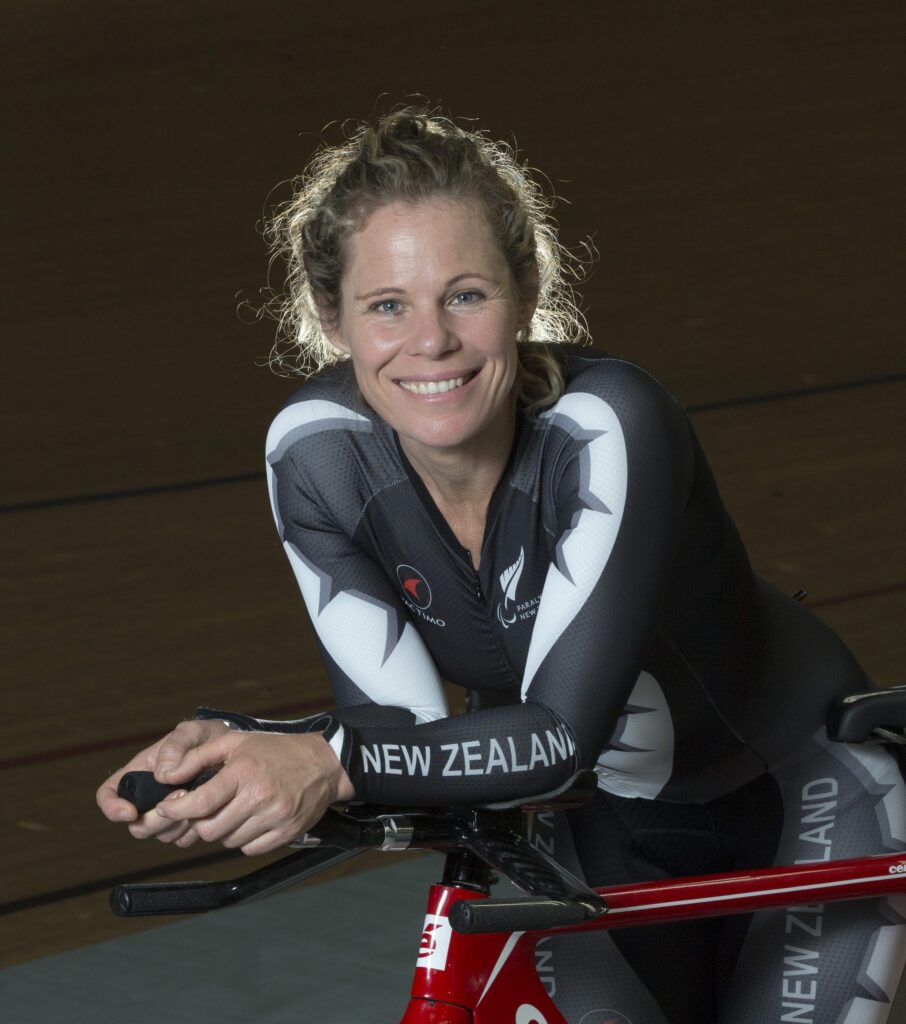 Kate Horan smiles while riding a bike.
