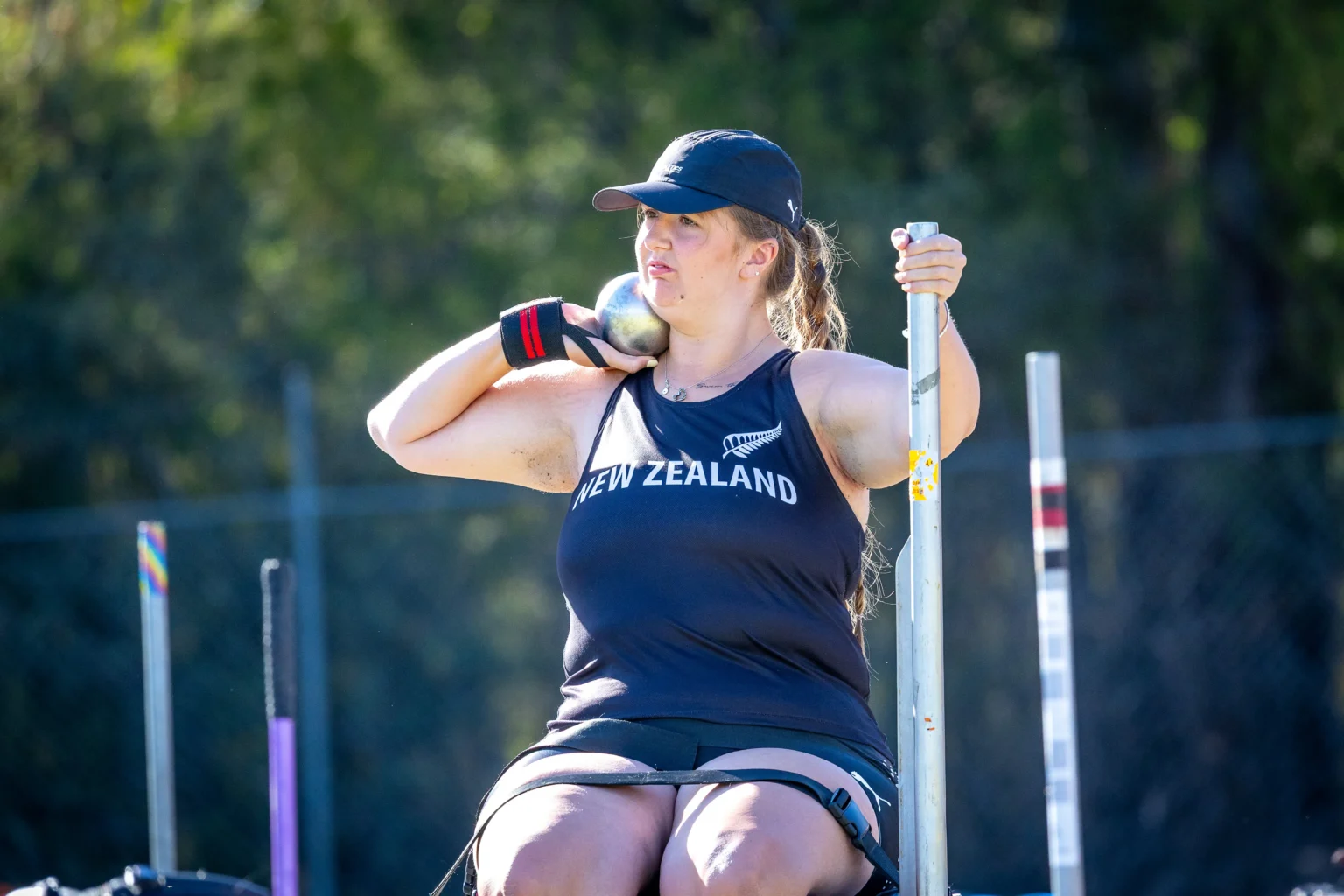 Milly Marshall-Kirkwood prepares to throw a shot put from a throwing frame. Credit Jo Harlow.