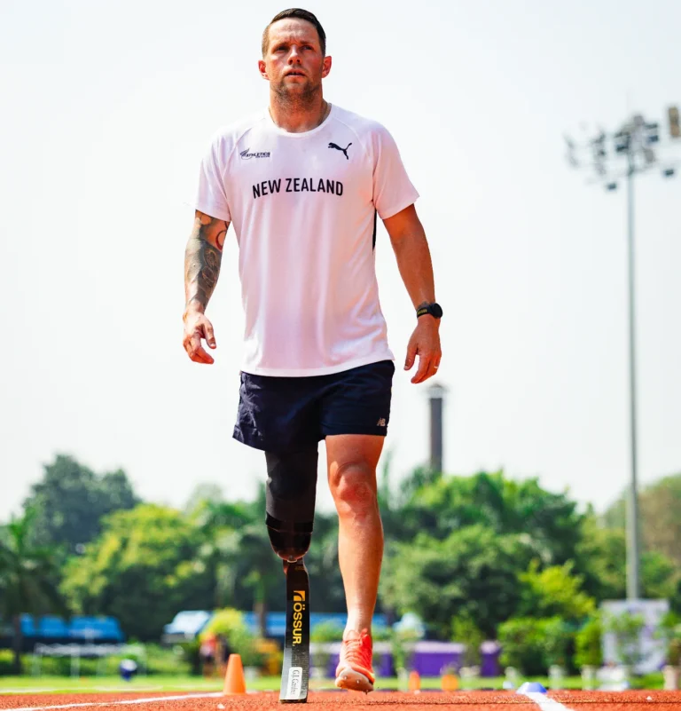 Mitch Joynt warms up on an athletics track.