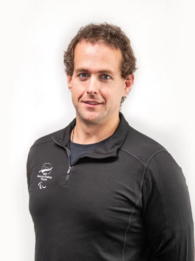 A formal portrait of Adam Hall.