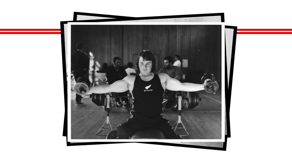 Paralympian #25 Brian McNicholl lifts two weights with his arms.
