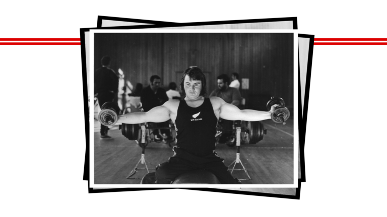 Paralympian #25 Brian McNicholl lifts two weights with his arms.