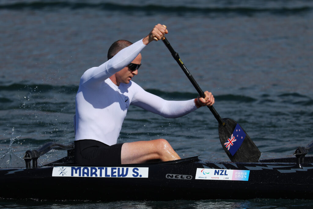 Para canoiest Scott Martlew paddling with a side on view at the Paris 2024 Paralympic Games.