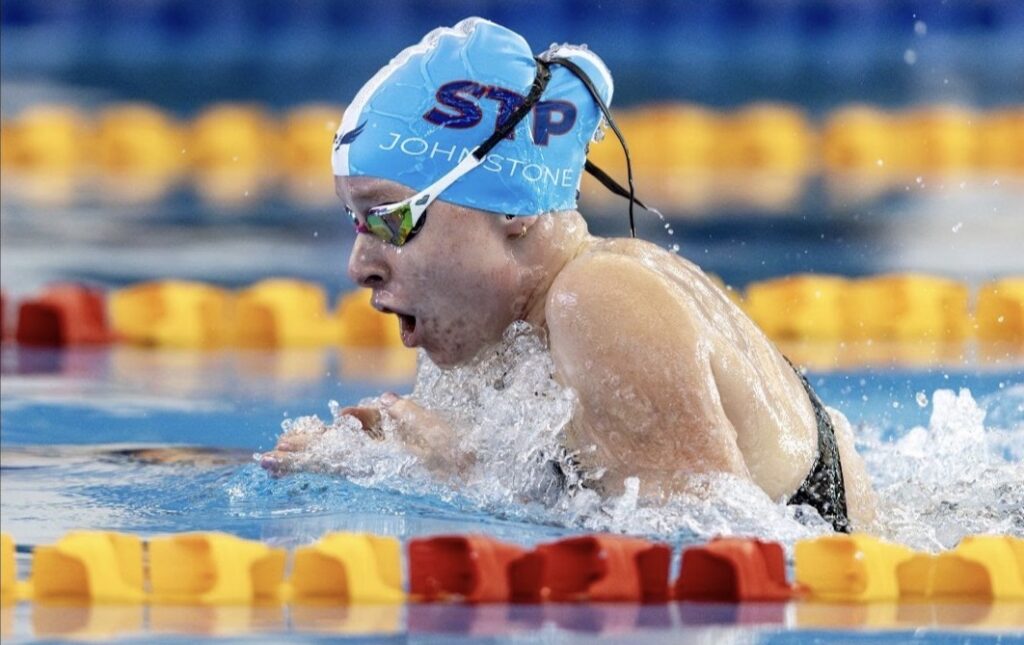 Jessica Johnstone in breaststroke action with a side on view.
