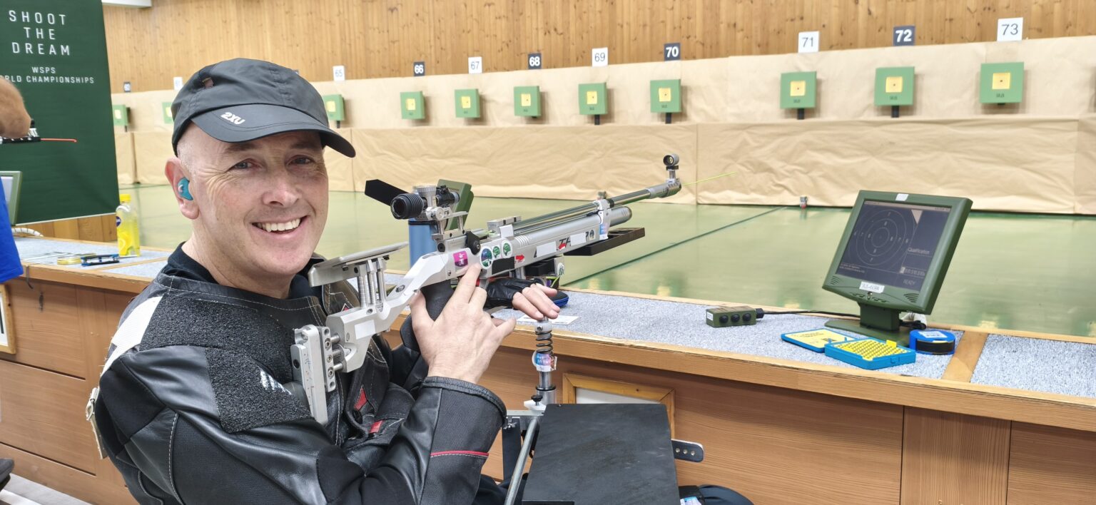 Michael Johnson smiling with his rifle in hand at the Changwon 2026 WSPS World Championships.