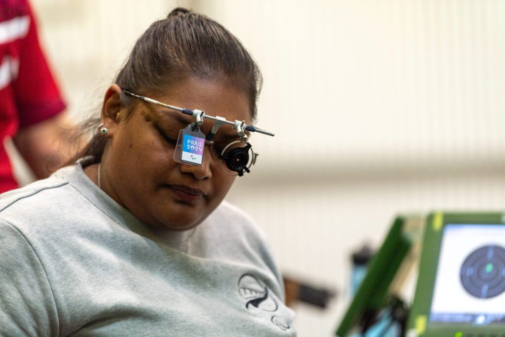 Paralympian #236 Neelam O'Neill gets ready to fire a pistol in competition.